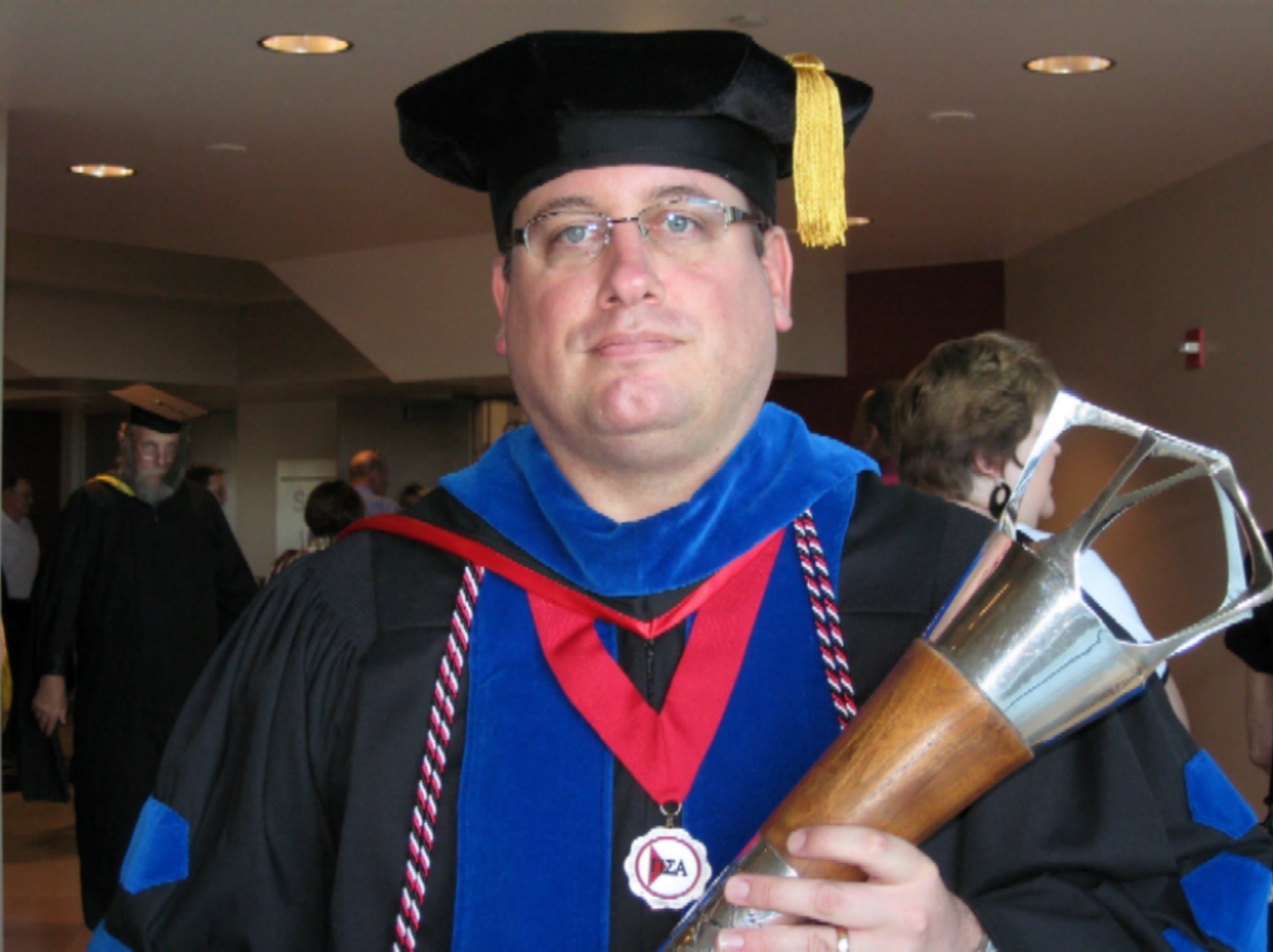 Dr. Dave Rausch holding WTAMU mace