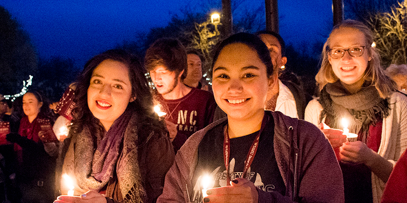 students holding candles