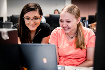 coess-edu-female-students-computer-on-campus