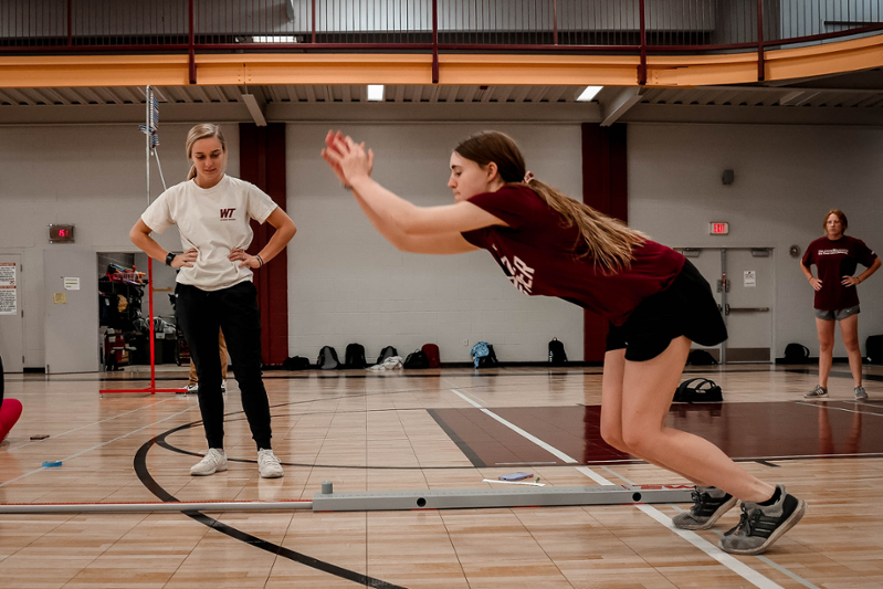 ses-female-students-jumping-all-purpose-room-2022