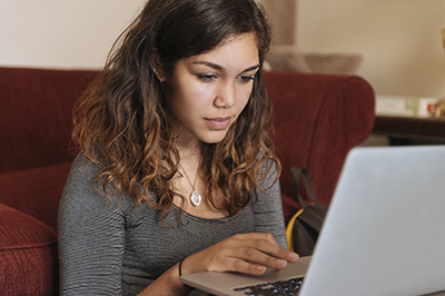 student-studying-computer-couch-400x266