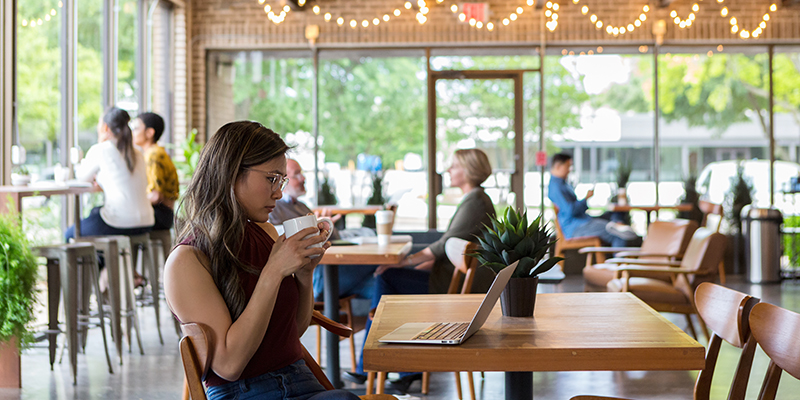 woman-reading-laptop-coffee-shop