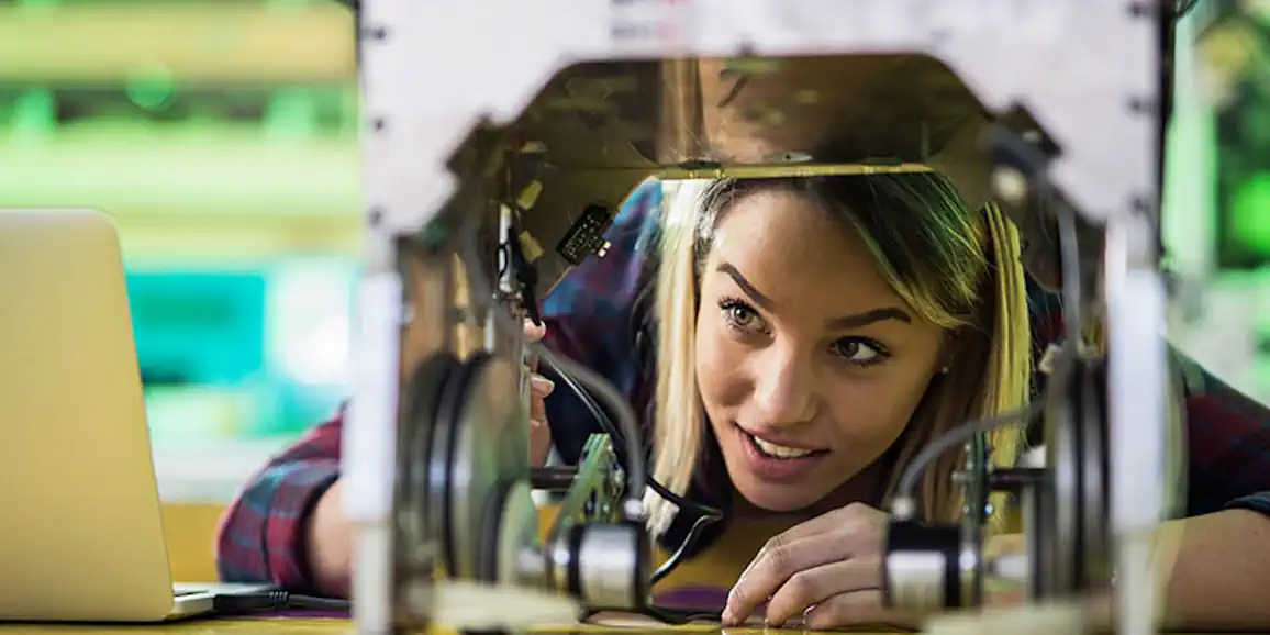female-student-looking-down-at-3d-printer