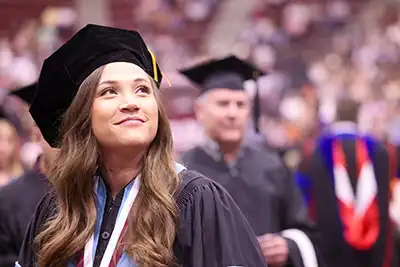Female Doctoral Graduate Looking Upward
