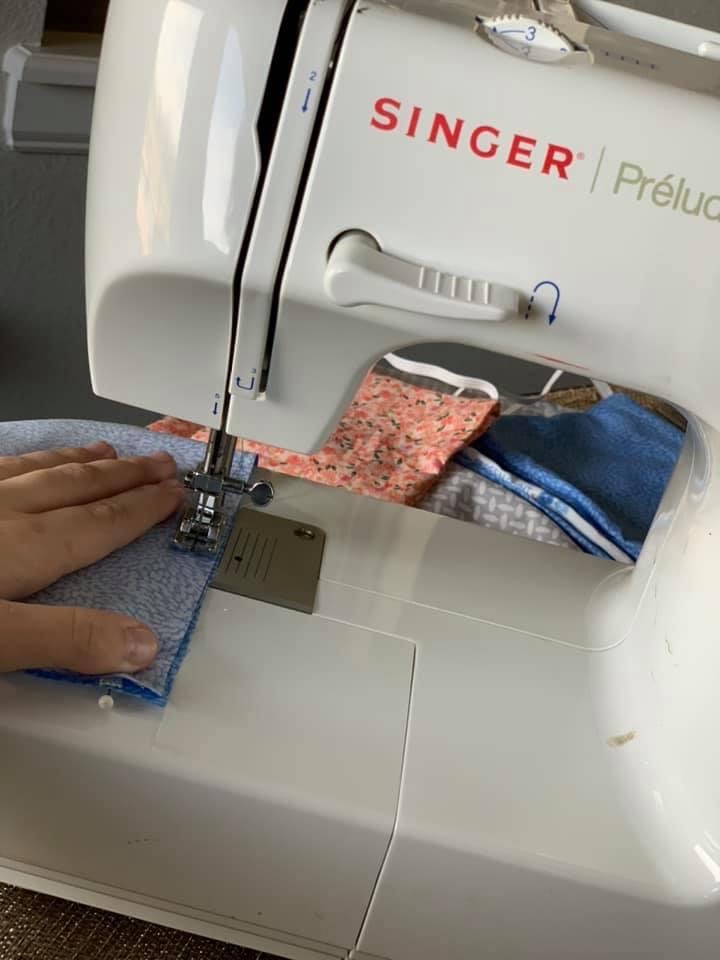 Hannak sewing a mask