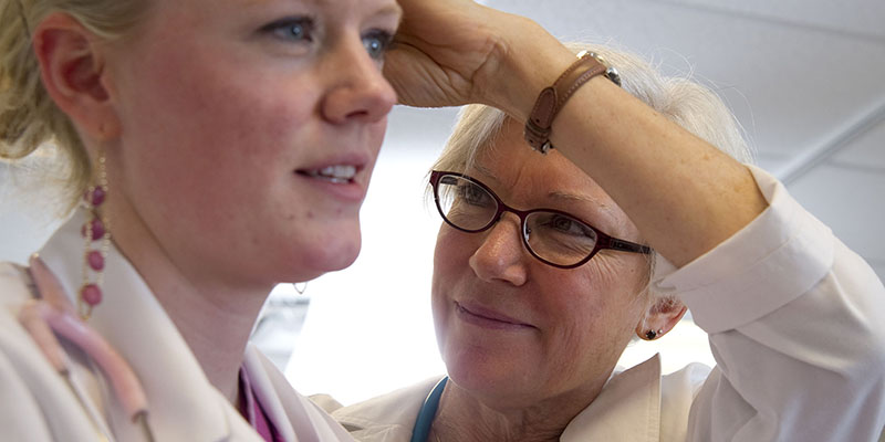 doctor examining patient's ear