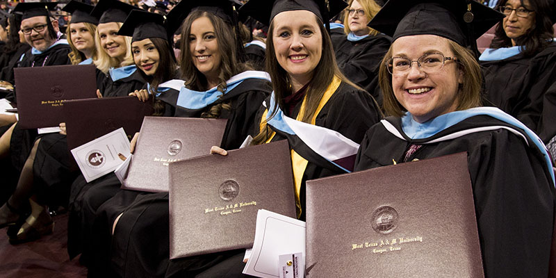 graduates showing diplomas