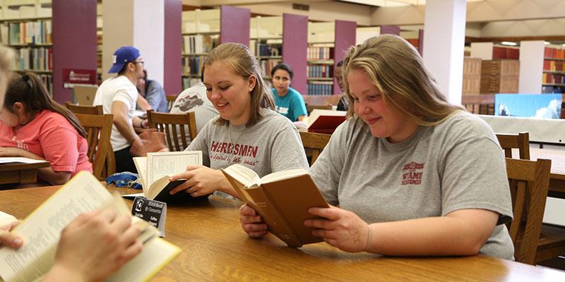 professor speaking with two individuals