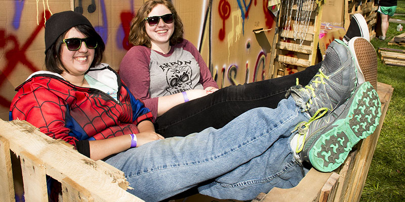 Students relaxing in front of building