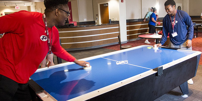 students playing air hockey