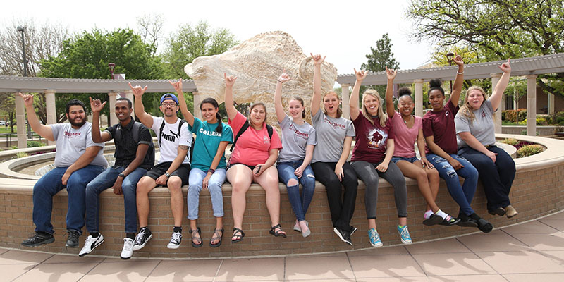 students sitting on a wall