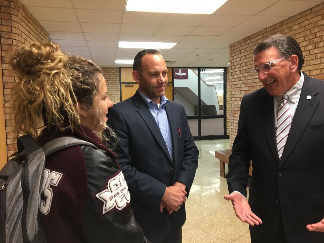 Dr. Walter Wendler speaks with a high school student and her father.